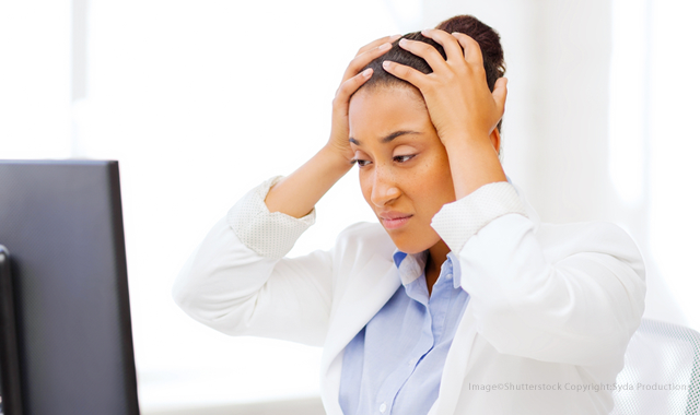 Frustrated health care professional in front of a computer screen