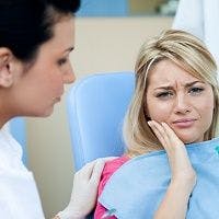 Woman with dental pain - Women Expect, Tolerate More Pain at Dentist