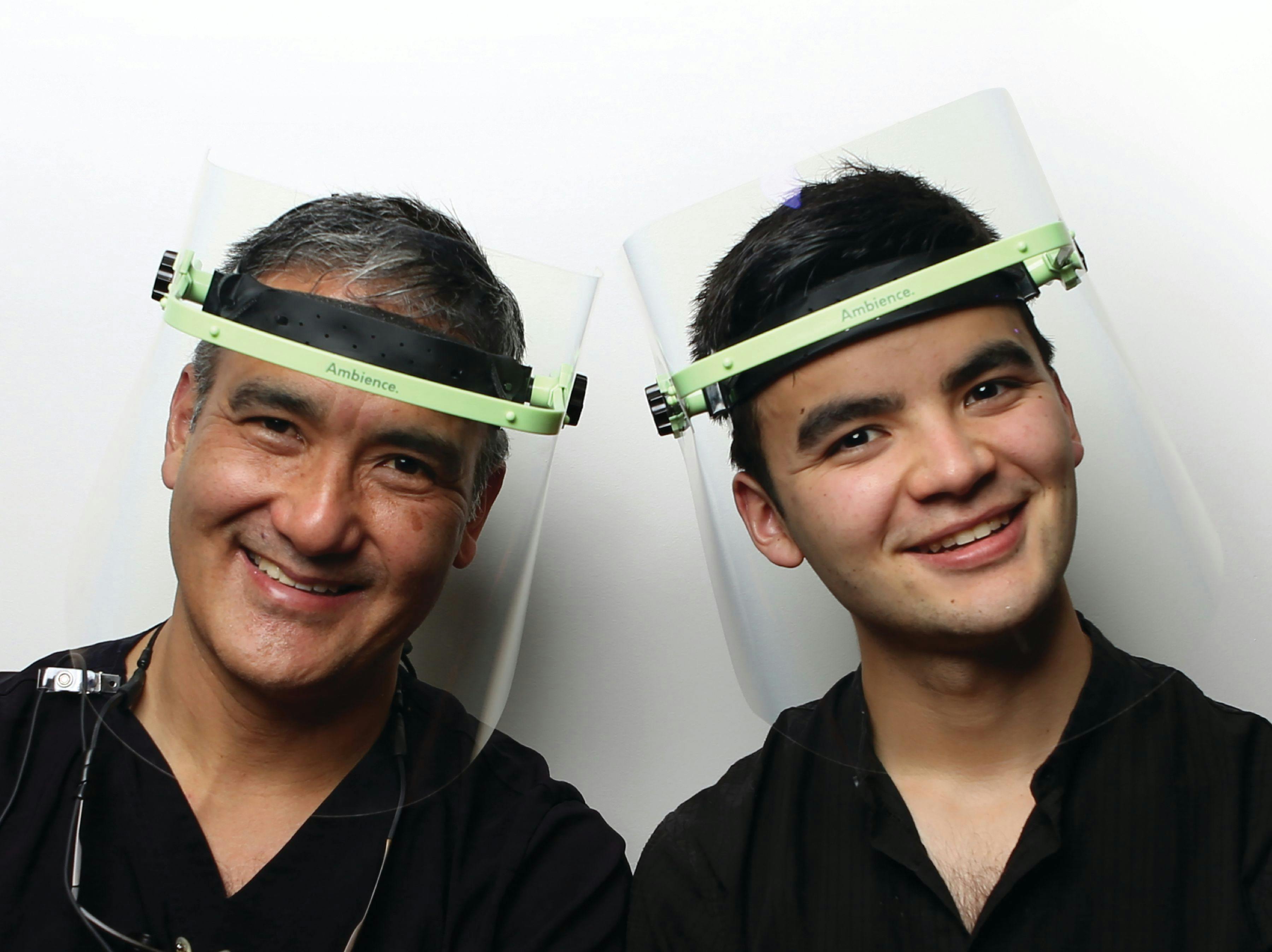 Dr Yamaoka and Zach Yamaoka smile together wearing the AmbiencePPE face shield