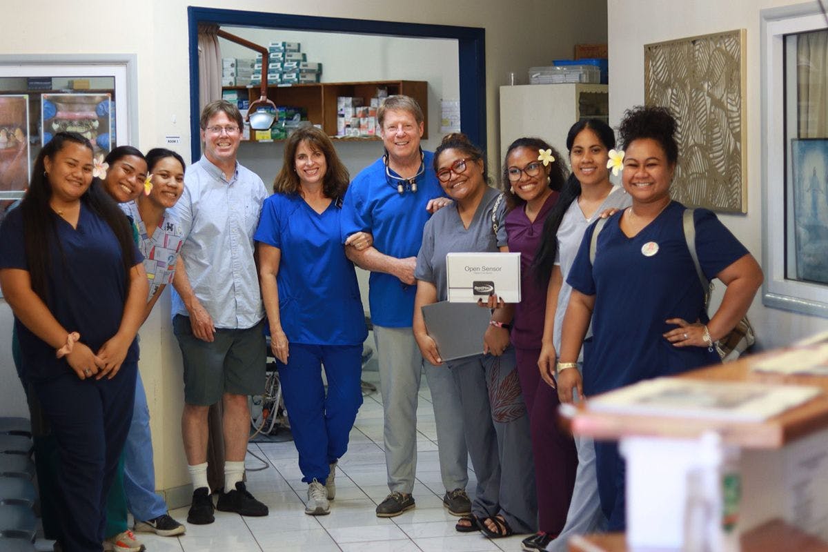 Steven Titensor, DDS, (center) and his wife Lisa Titensor are volunteer missionaries who run the Church of Jesus Christ of Latter-day Saints’ dental clinic in Samoa. | Image Credit: © DentiMax
