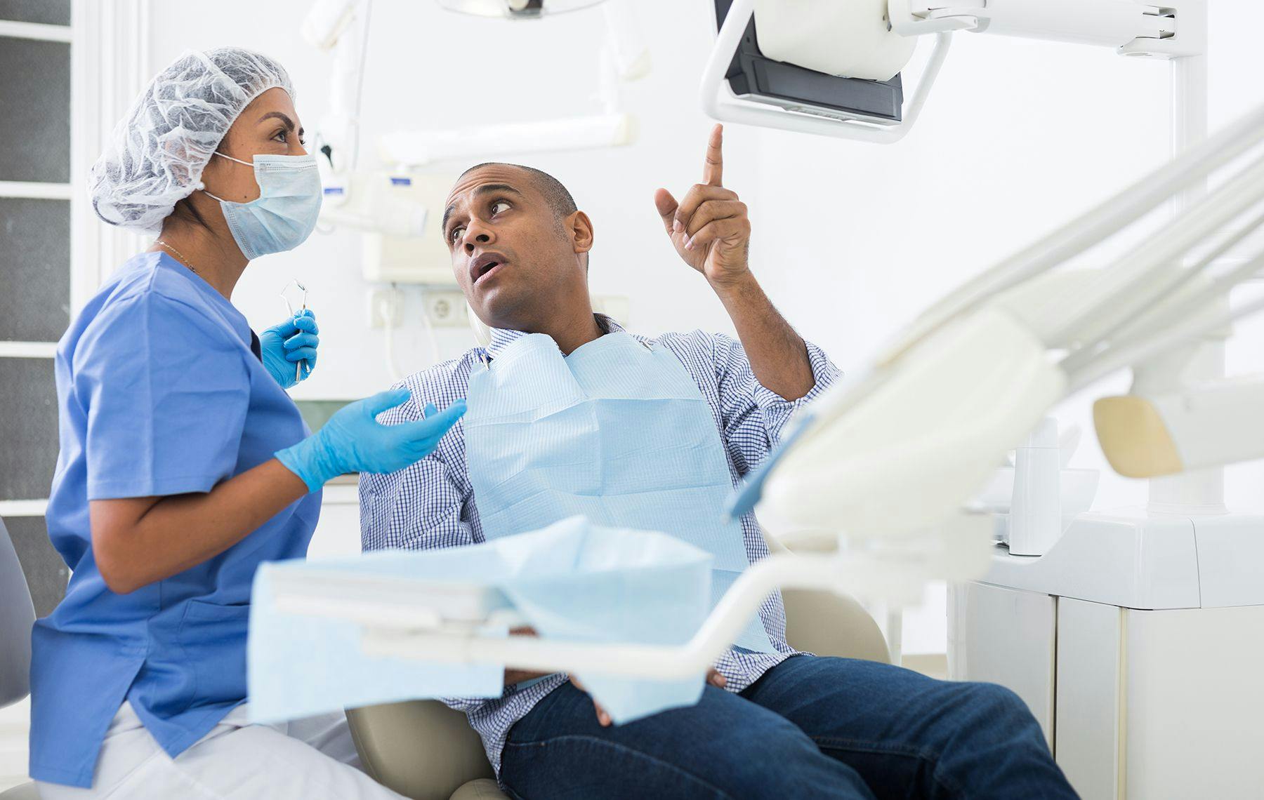 Hygienist Explaining x-rays to a dental patient | Image Credit: © Jack F / stock.adobe.com
