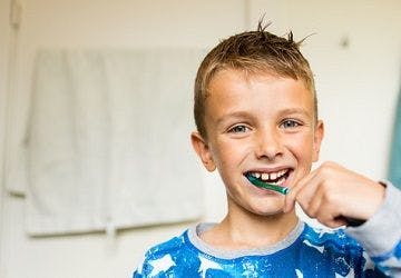 Photo of a child brushing his teeth